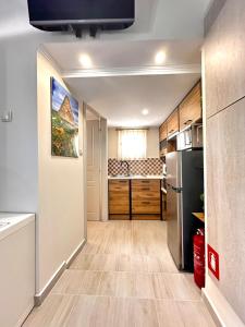 a kitchen with a refrigerator and a counter at Limnos Twin Pine in Néa Koútali +13 photos