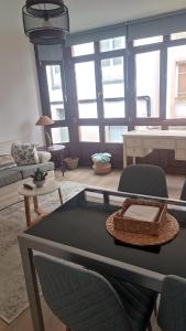 una sala de estar con una mesa y sillas en Apartamento Galería Cine Colón, en Ribadeo
