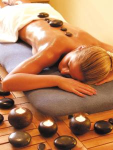 a woman laying on top of a massage at Hotel Pri mostu in Dolenjske Toplice