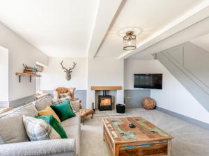 a living room with a couch and a table at Clearview - Cottage in Barlow