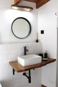a bathroom with a white sink and a mirror at Sunset Little House in Aljezur +17 photos