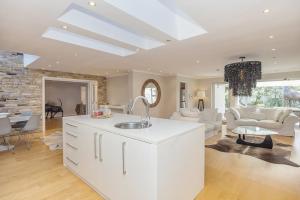 a kitchen and living room with a vaulted ceiling at The Island Beach Villa in Cape Town +49 photos