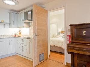 a kitchen with a door leading to a bedroom at The Bunker in Sennen