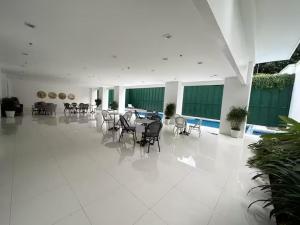 a dining room with tables and chairs in a building at Pontefino Condominium OPT705 1BR in Batangas City