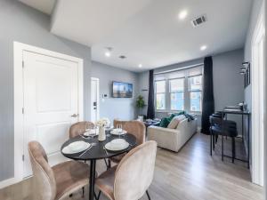 a living room with a table and chairs at Stylish Secret, 1 FREE Parking, Sleeps 8, Walk to train and Red Bull Arena, 20 Percent OFF in Harrison