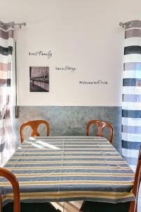 a dining room table with a blue and white striped table cloth at La casa azzurra in LʼAquila
