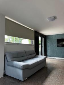 a living room with a couch and a window at Belvedere Costinesti in Costinesti +40 photos