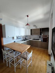 a kitchen with a wooden table and chairs at Casa vacanze Brezza del Mar in Alghero