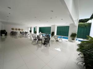 a dining room with tables and chairs in a building at Condominium Classy OPT 405 1BR 42sqm in Batangas City