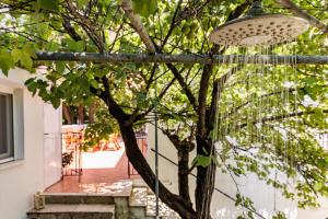 a light hanging from a tree in a yard at Villa Mitsa in Kolios