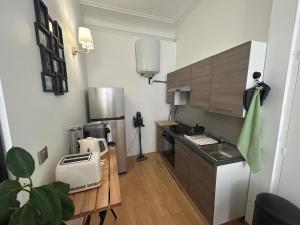 a small kitchen with a sink and a counter at T2 centre historique écusson in Montpellier