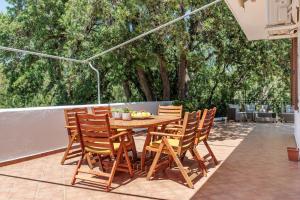 a wooden table and chairs on a patio at Villa Mitsa in Kolios