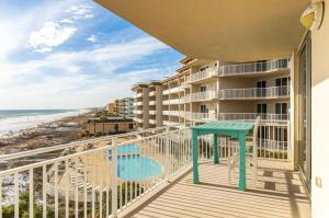 a balcony with chairs and a view of the beach at Gulf-Front Waterscape B401 Sundrenched in Fort Walton Beach