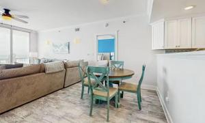 a living room with a couch and a table and chairs at Gulf-Front Waterscape B401 Sundrenched in Fort Walton Beach