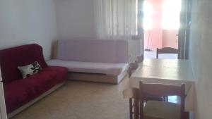 a living room with a couch and a table at Apartmani Trputec, otok Vir in Vir +13 photos