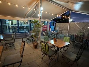 a restaurant with tables and chairs under a tent at Formula 1 Motel in Byala Ruse