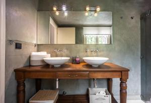 a bathroom with two sinks and a mirror at A Majestic Oasis in Keramikos, the Heart of Athens in Athens +90 photos