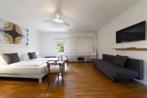 a living room with a bed and a couch at Torbole Holiday House in Nago-Torbole