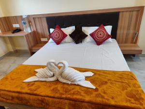 two swans made out of towels on a bed at SB homestay in Veer Savarkar International Airport