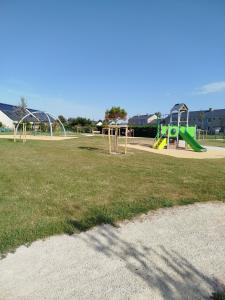 a park with a playground with a slide at Maison de vacances près de la mer à Créances in Créances
