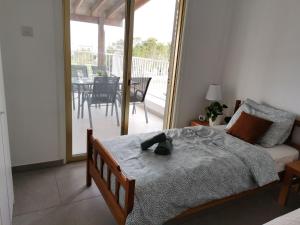a bedroom with a bed with a hat on it at Apartment Sun Kapparis in Paralimni