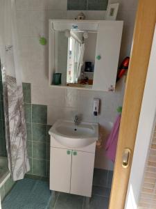 a bathroom with a sink and a mirror at Apartman Karo in Vrsar