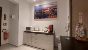 a kitchen with a counter and a painting on the wall at La Pilozza Guest Rooms in Gallipoli