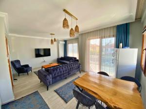 a living room with a couch and a table at Sea View Fethiye in Fethiye