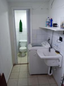 a bathroom with a sink and a toilet at Casa Tomazella in Guarujá