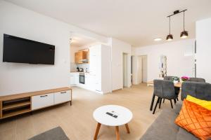 a living room with a couch and a table at ColorsVibe Apartment in Trogir