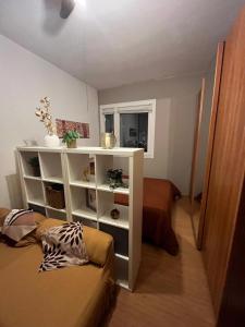 a room with a white book shelf and a couch at Dream's Tower BO in Bologna