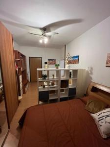a room with a bed and a ceiling fan at Dream's Tower BO in Bologna