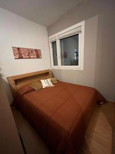 a bedroom with a large bed with a window at Dream's Tower BO in Bologna