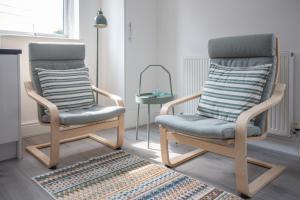two rocking chairs in a living room with a rug at Lytham St Annes Luxury Apartment - No 1 Tides Reach in Lytham St Annes