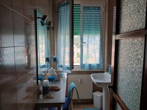 a bathroom with a shower and a sink and a window at Appartamento Miramare in Lerici
