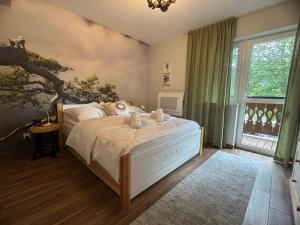 a bedroom with a bed and a large window at JW Apartments in Krościenko