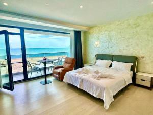 a bedroom with a bed and a view of the ocean at miami costinesti in Costinesti