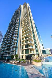 a large building with a pool in front of it at Luxury Apartments - Urban Oasis by Missoni - Business Bay - Canal View - 10 Minutes from Dubai Mall Burj Khalifa in Dubai