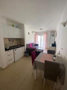 a kitchen and living room with a table and a couch at Friends in Kravlja +10 photos