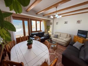 a living room with a table and a couch at Casa Rural La Petita in Tibi