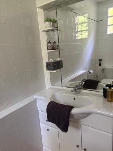 a white bathroom with a sink and a mirror at Chambre d'Hôtes du Domaine de Gargoris, Terrasse Privée & Piscine in Pont-du-Casse