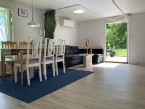 a dining room and living room with a table and chairs at The Meadow House in Gothenburg