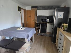 a small kitchen with a table and a refrigerator at Ferienwohnung Casa Azul Hx in Höxter