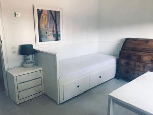 a bedroom with a bed and a nightstand and a picture at Girona m'enamora in Girona +5 photos