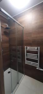 a bathroom with a glass shower with a ceiling at Apartamenty Kraków-Bielany in Kraków
