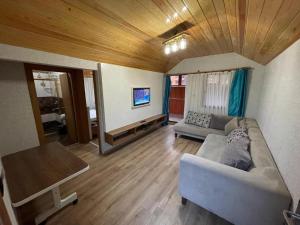 a living room with a couch and a table at Centro Park Hotel in Uzungöl