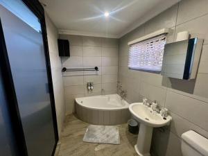 a bathroom with a tub and a sink at Antelope Farm Events in Pretoria +25 photos