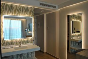 Un baño con dos lavabos y un espejo grande. en Hotel Delfin Azul, en A Lanzada 37 fotos más