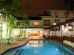 a swimming pool in front of a building at Premier Splendid Inn Pinetown in Pinetown
