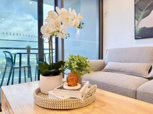 a living room with a couch and a table with flowers at Skyline Poetry - Premium Stay on the Star BNE in Brisbane +26 photos